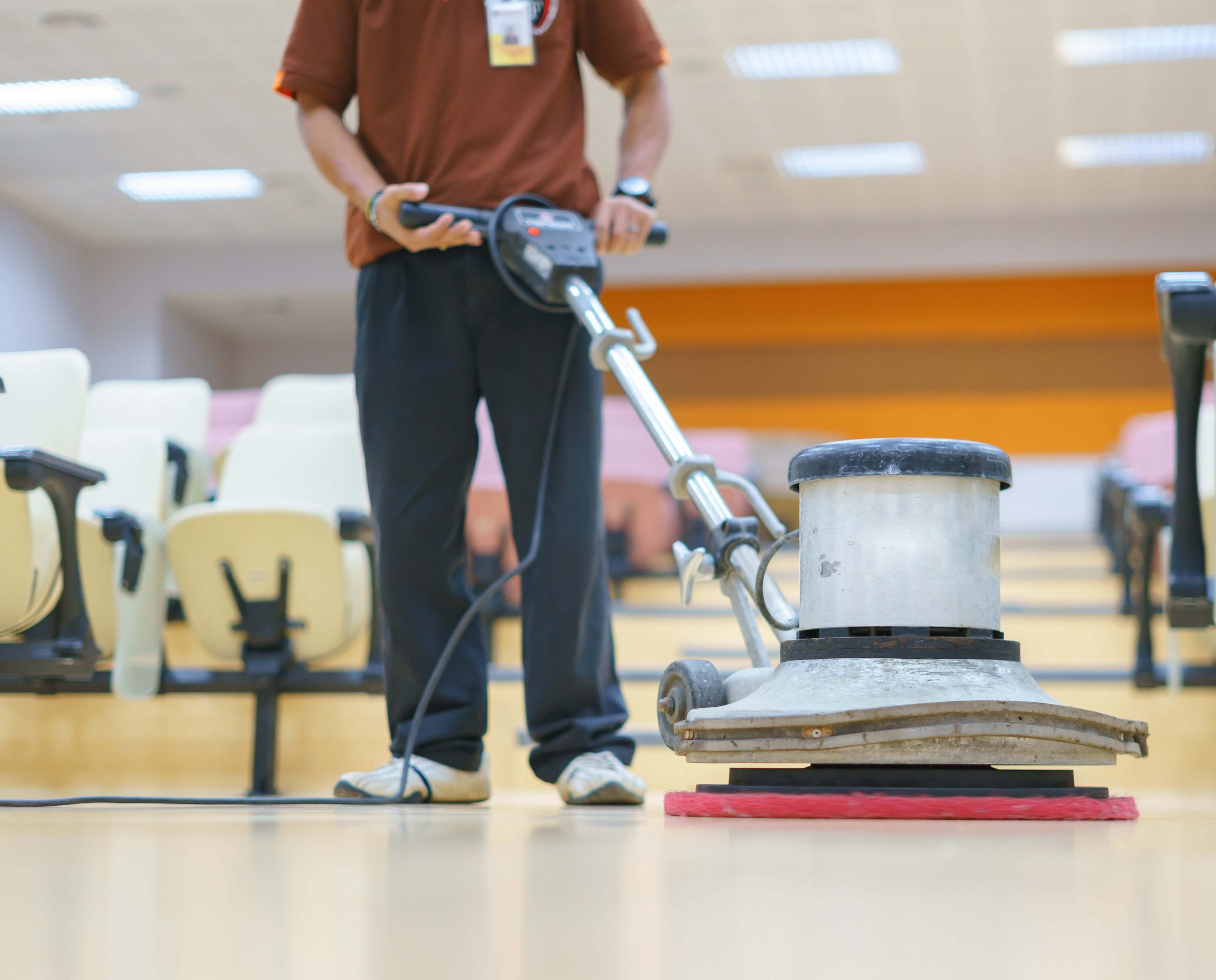 Asian worker cleaning ground surface